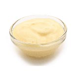 Yellow cream cheese in a small glass bowl