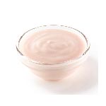 Orange cream cheese in a small glass bowl