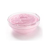 Pink cream cheese in a small glass bowl